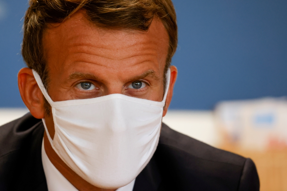 French President Emmanuel Macron, wearing a protective face mask, meets staff and parents during a visit to a center for Maternal and Child Protection (PMI) in Longjumeau, near Paris, France September 23, 2020. Ludovic Marin/Pool via REUTERS