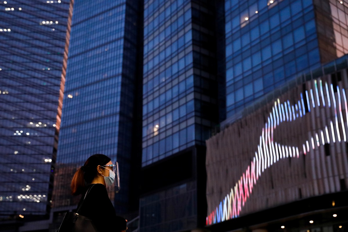 A woman wearing a face mask and face shield for protection against the coronavirus disease (COVID-19) is pictured at a financial district in Bonifacio Global City, Taguig, Metro Manila, Philippines, September 22, 2020. REUTERS/Eloisa Lopez
