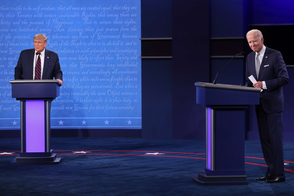 US President Donald Trump and Democratic presidential nominee Joe Biden look out to the audience at end of the first presidential debate at the Health Education Campus of Case Western Reserve University on September 29, 2020 in Cleveland, Ohio. Win McName