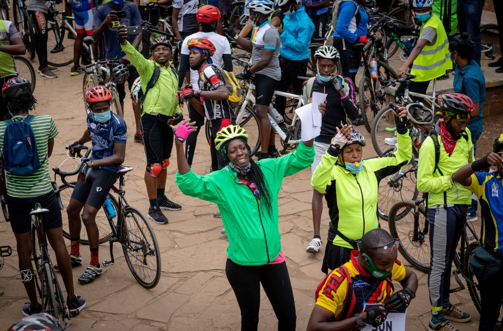 Cyprine Odada (C), organiser for the Nairobi chapter of Critical Mass, a global alliance of cycling organisations that campaigns for better road safety, gestures among cyclists as they commemorate a friend who was killed while cycling in Nairobi, Kenya Se