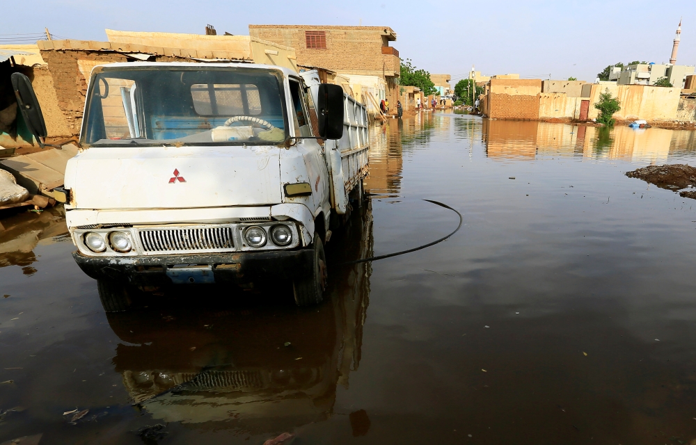 FILE PHOTO: A truck is seen in the waters of the Blue Nile floods within the Al-Ikmayr area of Omdurman in Khartoum, Sudan August 27, 2020. REUTERS/Mohamed Nureldin Abdallah