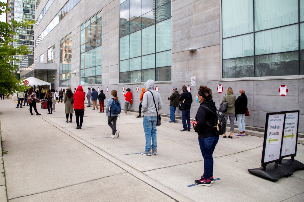 FILE PHOTO: People wait in line at the Women's College coronavirus disease (COVID-19) testing facility in TORONTO, Ontario, Canada September 18, 2020. REUTERS/Carlos Osorio/File Photo
