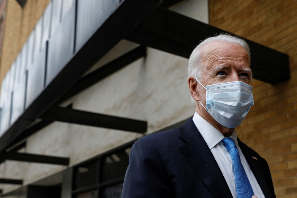 U.S. Democratic presidential candidate and former Vice President Joe Biden stops to answer questions as he exits The Queen theater in Wilmington, Delaware, U.S., October 1, 2020. REUTERS/Brendan McDermid