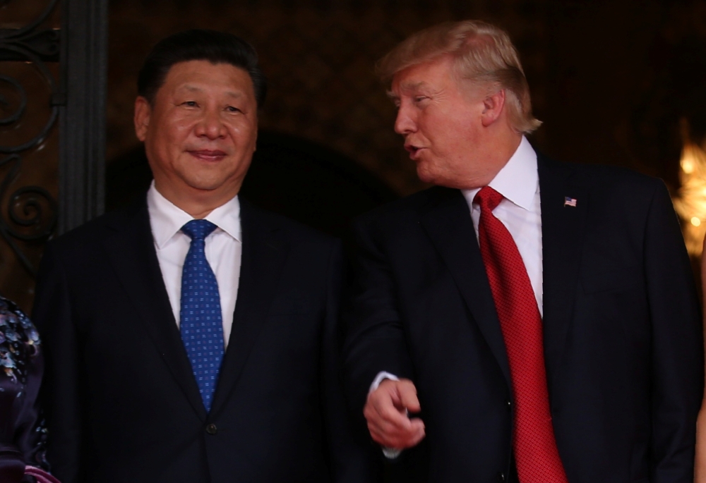 FILE PHOTO: U.S. President Donald Trump talks with Chinese President Xi Jinping as Xi arrives for dinner at the start of their summit at Trump’s Mar-a-Lago estate in West Palm Beach, Florida, U.S. April 6, 2017. REUTERS/Carlos Barria