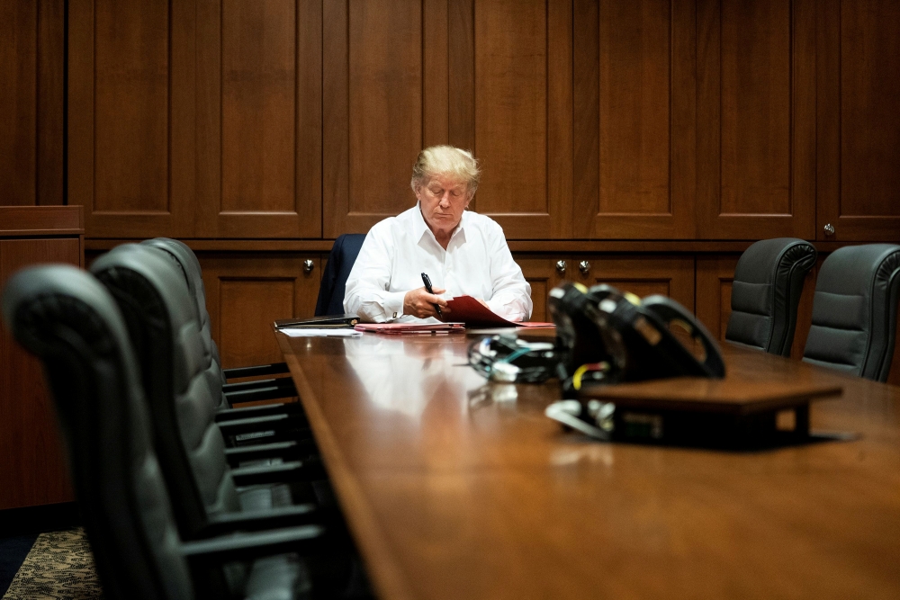 U.S. President Donald Trump works in a conference room while receiving treatment after testing positive for the coronavirus disease (COVID-19) at Walter Reed National Military Medical Center in Bethesda, Maryland, U.S. October 3, 2020. Joyce N. Boghosia/T