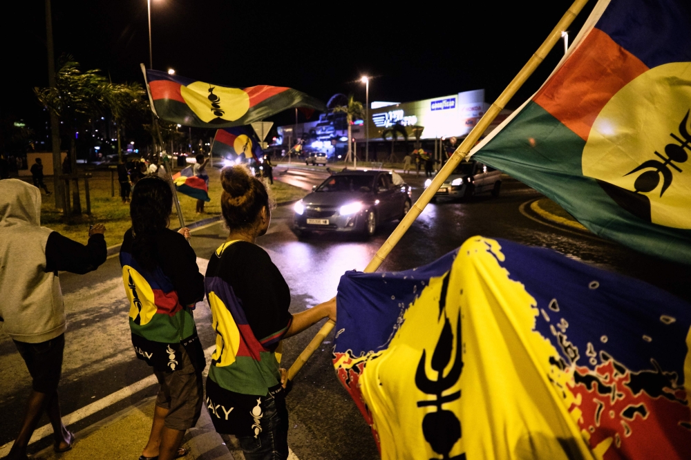 Kanak independence supporters wave flags of the Socialist Kanak National Liberation Front (FLNKS) after the referendum on independence on the French South Pacific territory of New Caledonia in Noumea on October 4, 2020. AFP / Theo Rouby