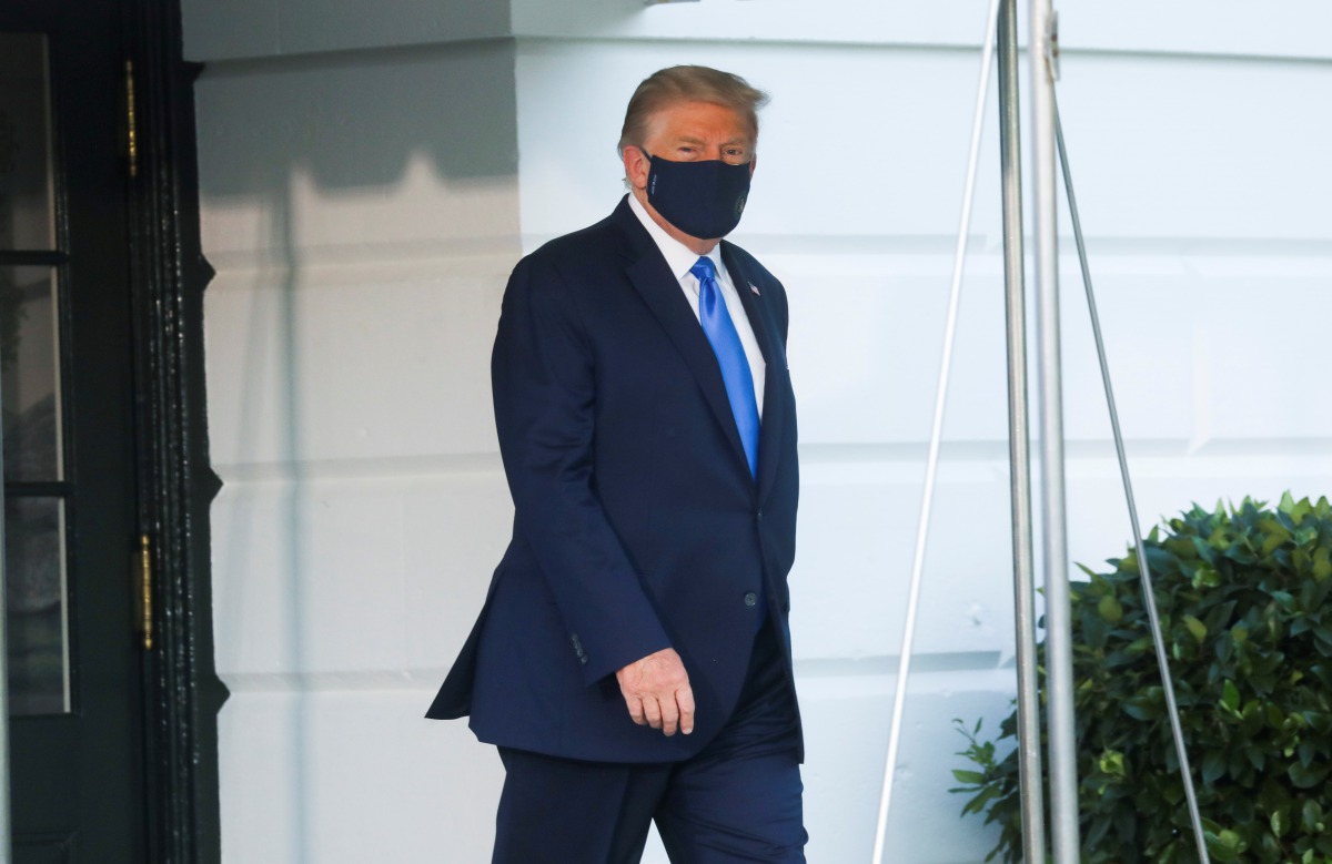 U.S. President Trump walks to the Marine One helicopter wearing a protective face mask as he departs the White House to fly to Walter Reed National Military Medical Center, where it was announced he will work for at least several days after testing positi