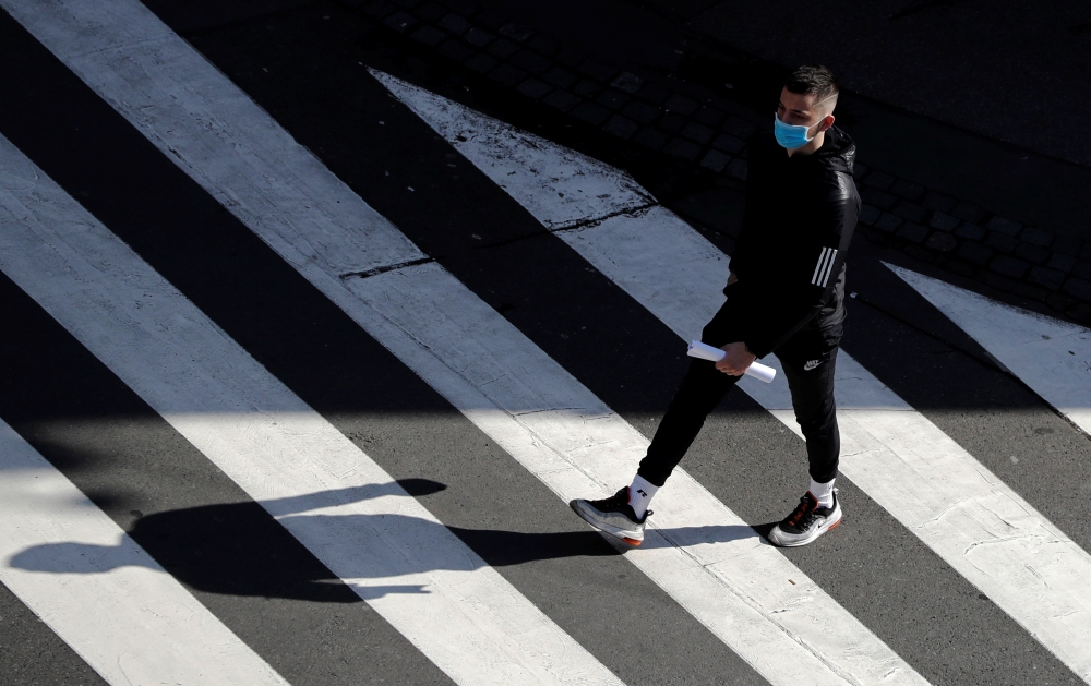 A man wearing a face mask walks on a crosswalk as the spread of the coronavirus disease (COVID-19) continues in Prague, Czech Republic, October 1, 2020. REUTERS/David W Cerny