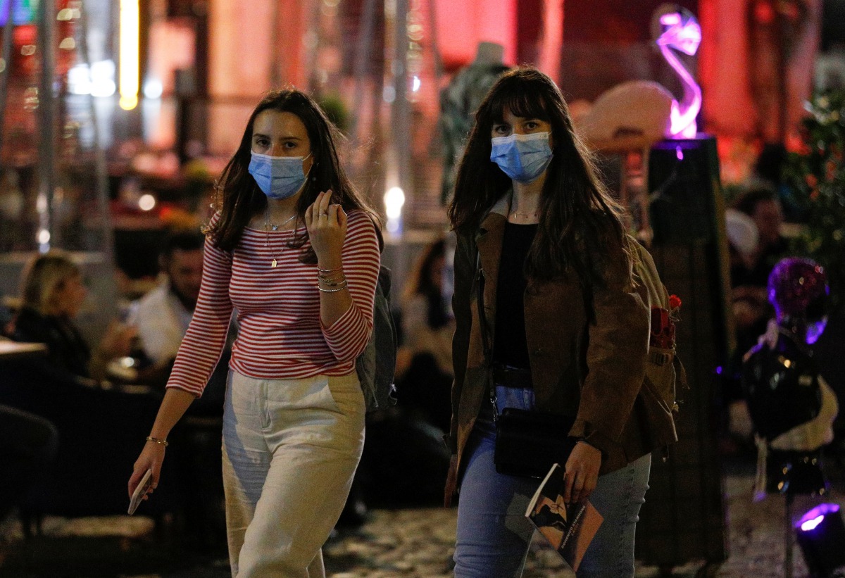 Women wearing protective face masks walk as local authorities in the Italian capital Rome order face coverings to be worn at all times out of doors in an effort to counter rising coronavirus disease (COVID19) infections, in Rome, Italy. October 6, 2020. R