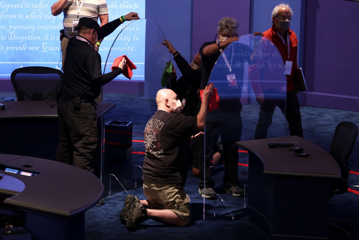 SALT LAKE CITY, UTAH - OCTOBER 06: Workers install plexiglass barriers on the stage ahead of the vice presidential debate in Kingsbury Hall of the University of Utah October 6, 2020 in Salt Lake City, Utah. U.S. Vice President Mike Pence and Democratic vi