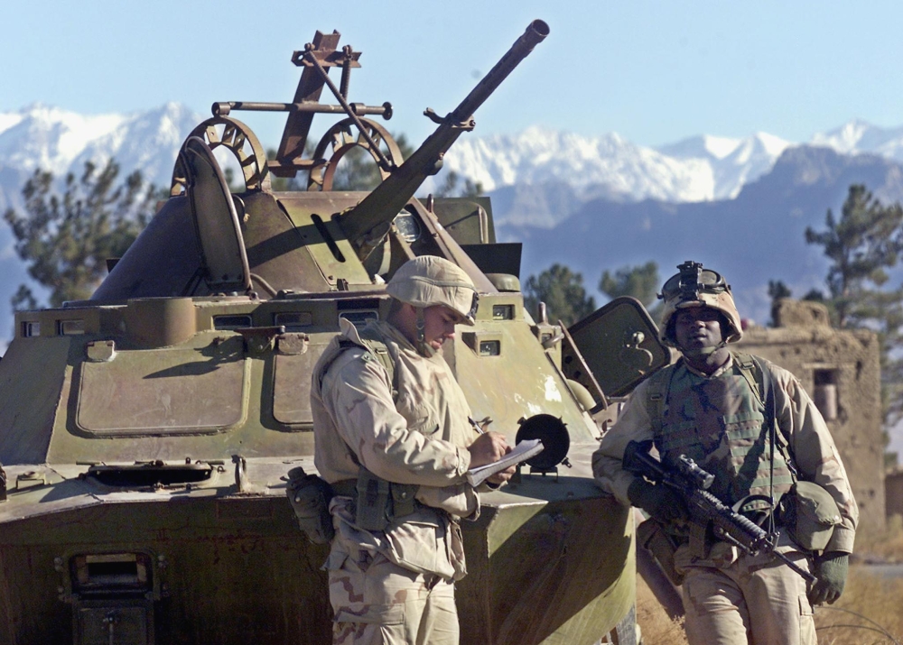 (FILES) In this file photo taken on December 8, 2001, American soldiers from the 10th Mountain Division stand guard at Bagram Air Base north of Kabul. AFP / WAKIL KOHSAR