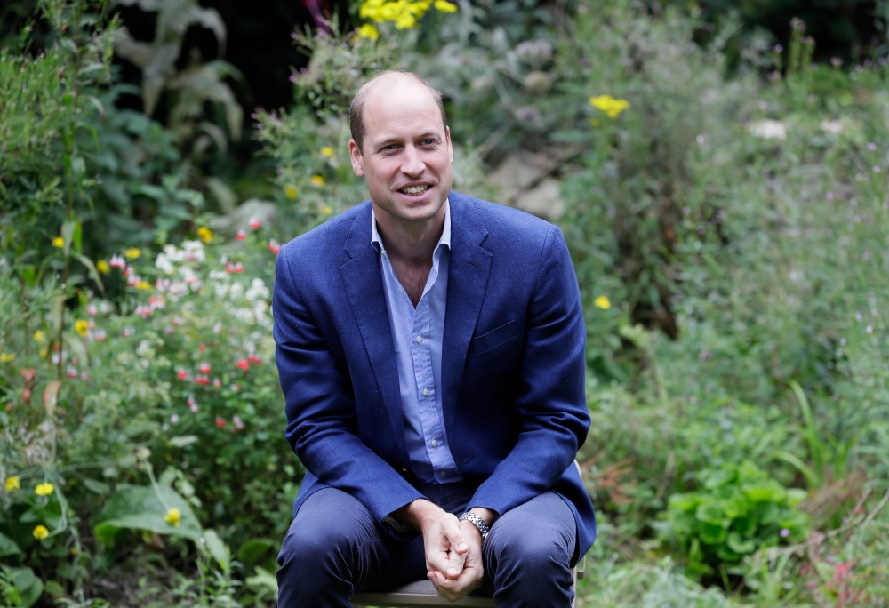 In this file photo taken on July 16, 2020, Britain's Prince William, Duke of Cambridge socially distances as he speaks with service users during a visit to the Garden House of the Light Project in Peterborough. Britain's Prince William on Thursday launche