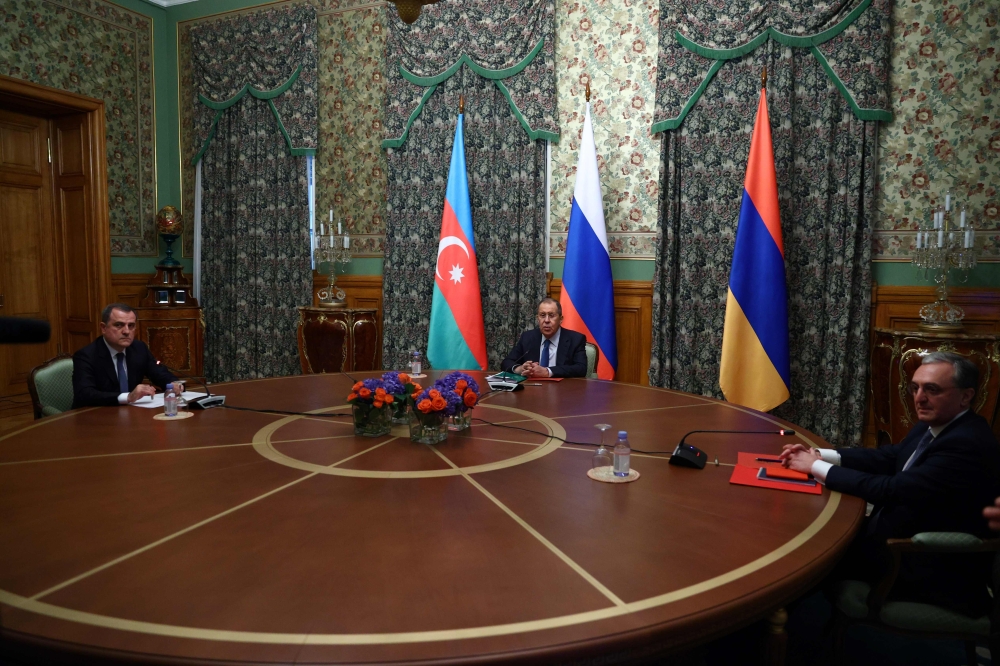 This handout photograph released by the Russian Foreign Ministry shows Russian Foreign Minister Sergei Lavrov (C) as he chairs a meeting of Armenia's Foreign Minister Zohrab Mnatsakanyan (R) and Azerbaijan's Foreign Minister Jeyhun Bayramov in Moscow on O