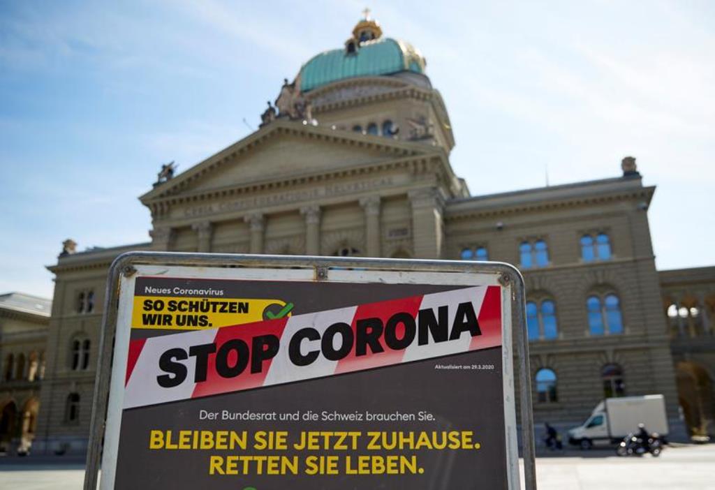 FILE PHOTO: A sign is pictured in front of the Swiss Parliament Building (Bundeshaus) during a federal council meeting on the outbreak of the coronavirus disease (COVID-19) in Bern, Switzerland, April 16, 2020. REUTERS/Denis Balibouse

