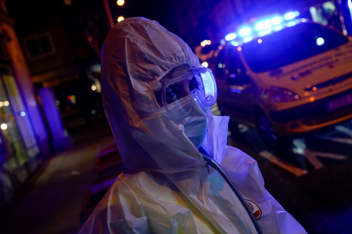 Madrid Emergency Service (SUMMA) UVI-8 unit's medical resident Mireya Nadal wearing full protective gear prepares to treat a patient in his home amid the coronavirus disease (COVID-19) outbreak in Madrid, Spain, October 19, 2020. Picture taken October 19,