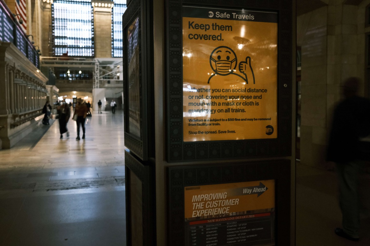 NEW YORK, NEW YORK - OCTOBER 21: A display at Grand Central Terminal shows how to wear a face mask on October 21, 2020 in New York City. Spencer Platt/AFP