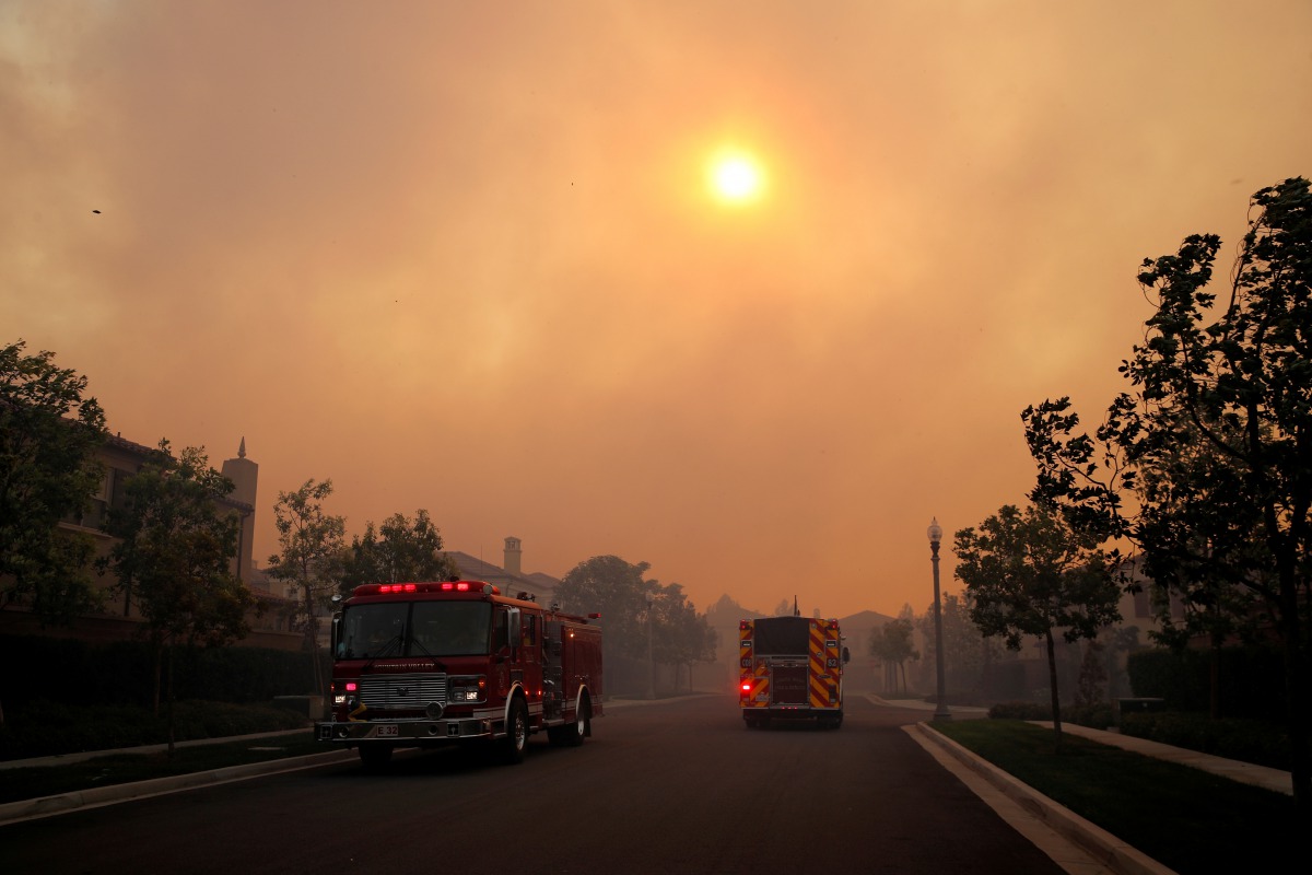 Fire trucks arrive as the Silverado Fire approaches, near Irvine, California, U.S. October 26, 2020. REUTERS/Mike Blake
