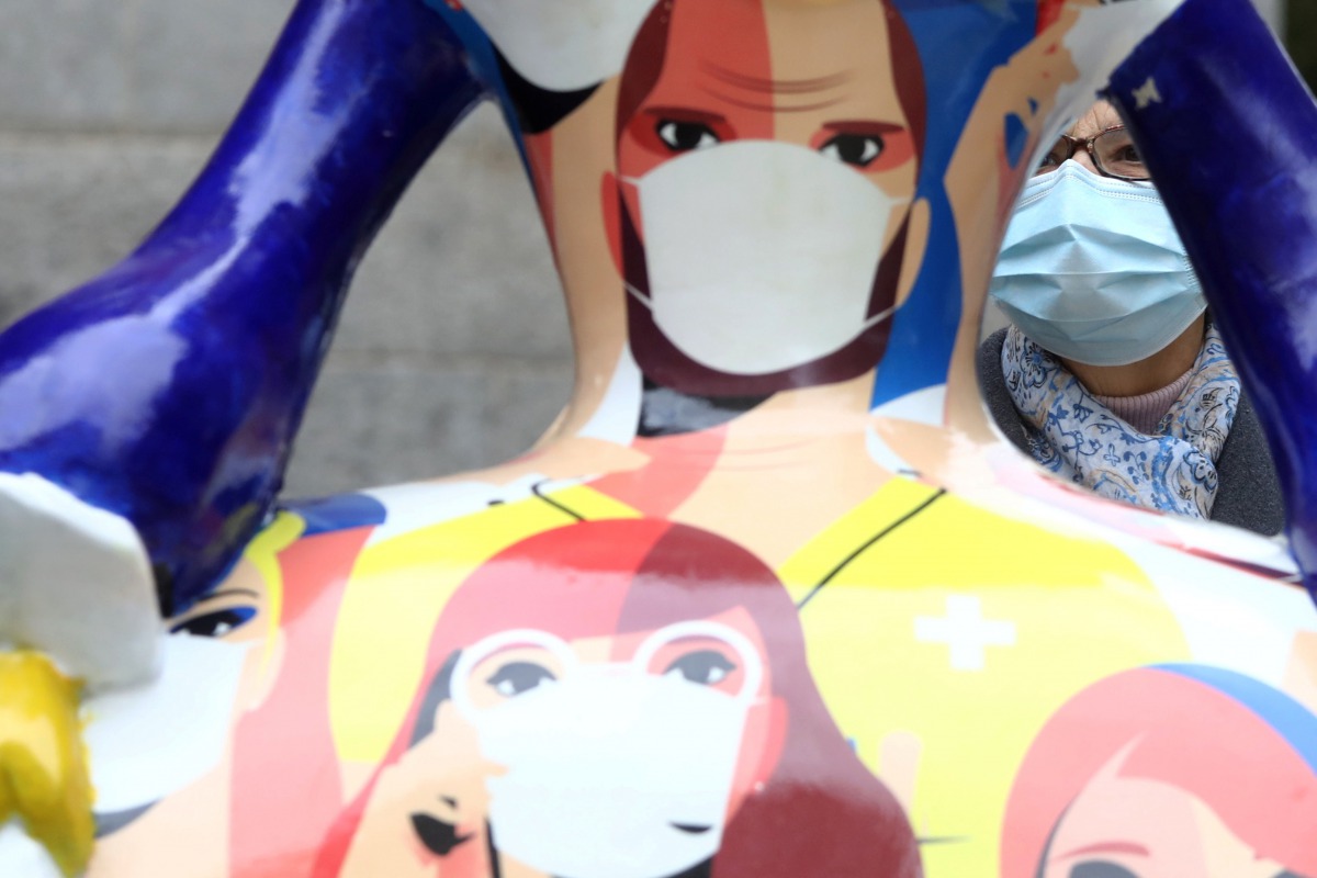 A woman takes a look of a sculpture of a 