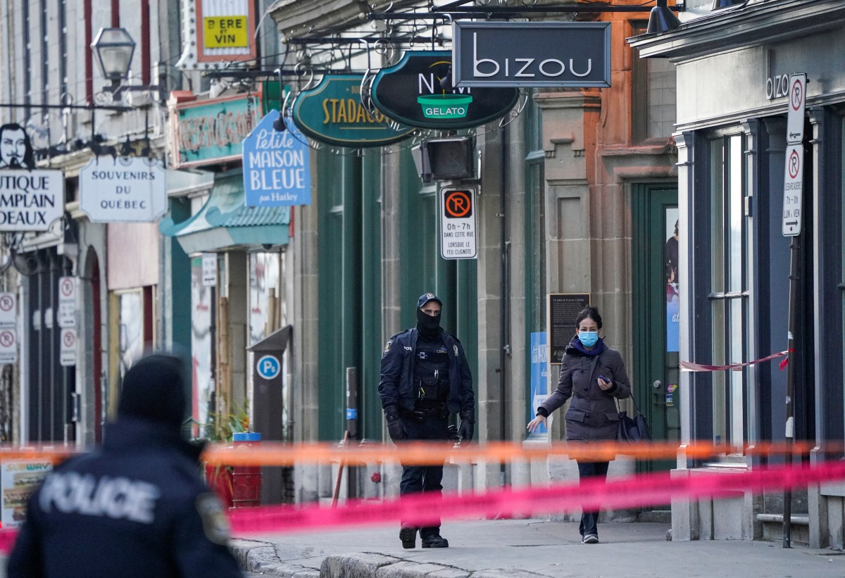 Police officers secure the area where multiple people were stabbed near the Parliament Hill area of Quebec City, Quebec, Canada November 1, 2020. REUTERS/Mathieu Belanger
