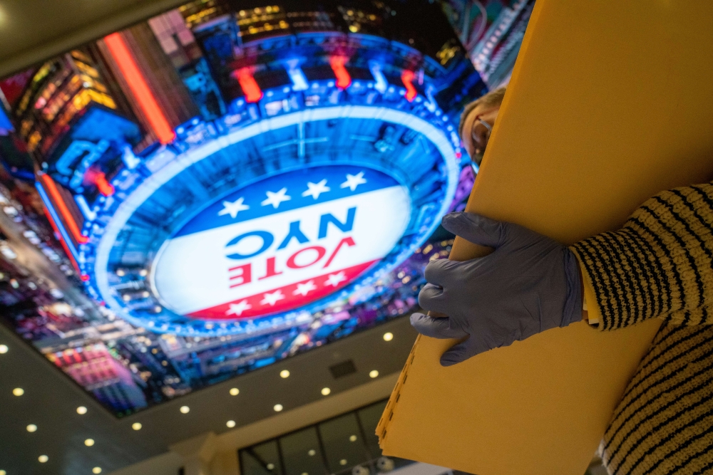 A poll worker holds empty folders of casted votes Madison Square Garden polling station on November 1, 2020 in New York City. David Dee Delgado/Getty Images/AFP
