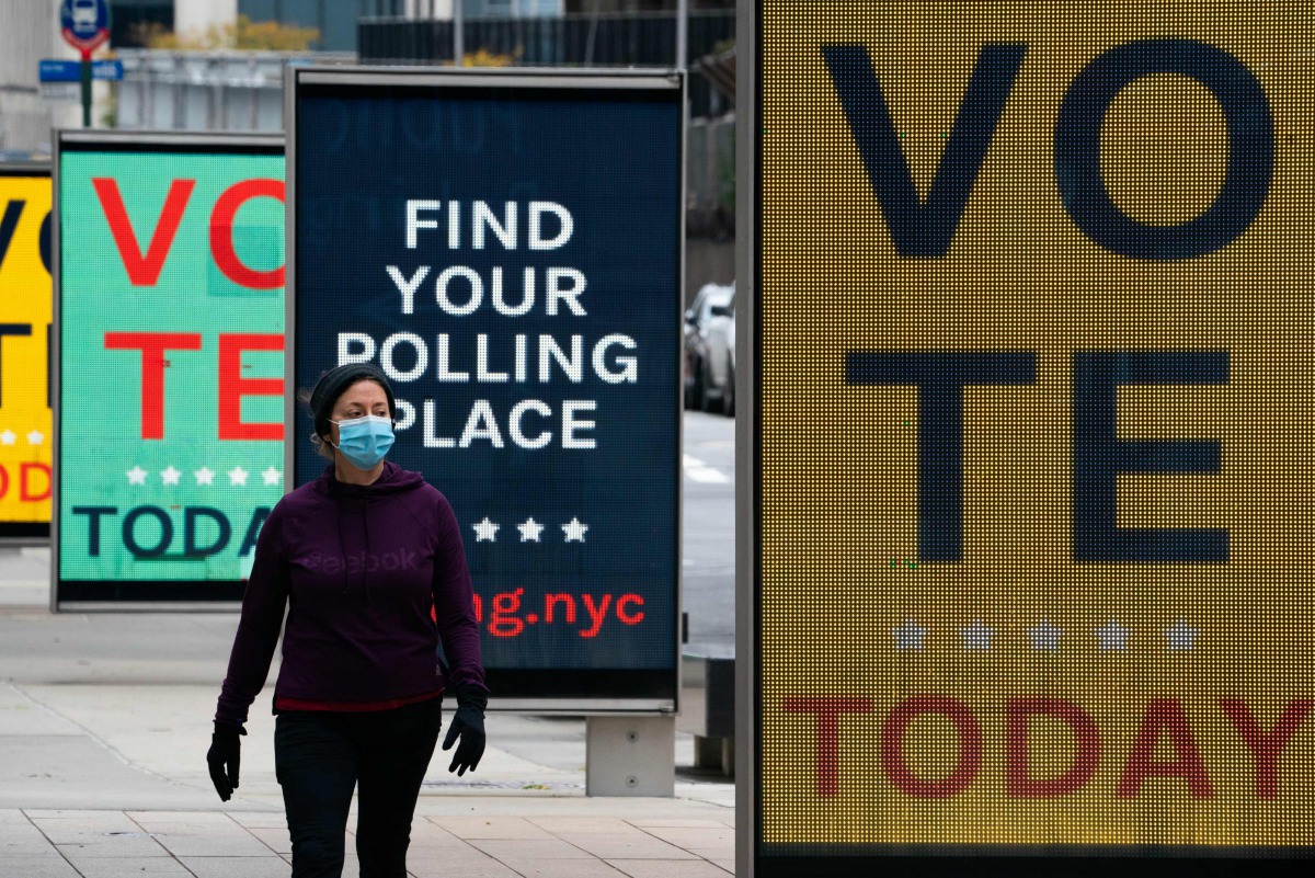 Video billboards urge people to vote at Lincoln Center on Election Day, November 3, 2020 in New York. Americans were voting on Tuesday under the shadow of a surging coronavirus pandemic to decide whether to reelect Republican Donald Trump, one of the most