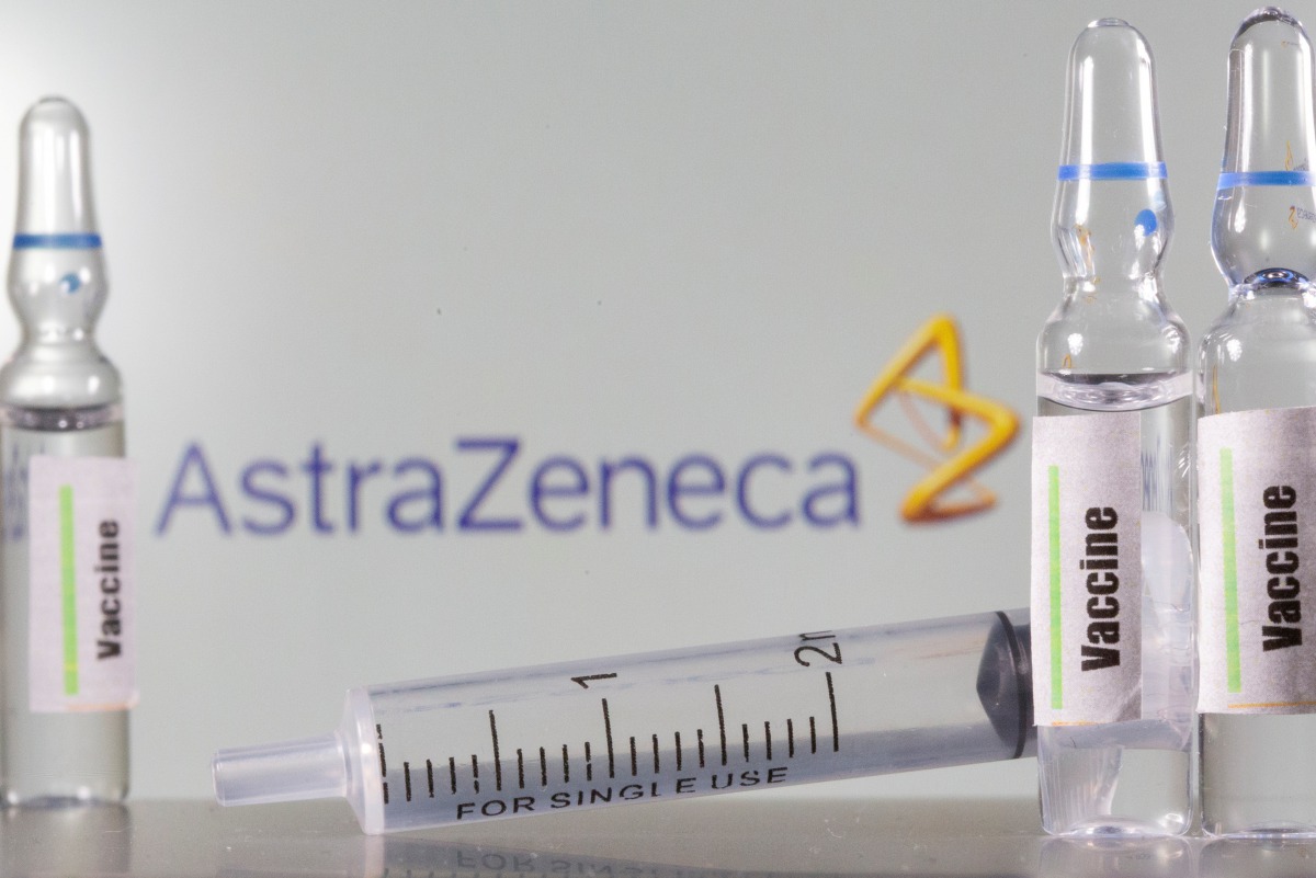 FILE PHOTO: A test tube labelled with the Vaccine is seen in front of AstraZeneca logo in this illustration taken, September 9, 2020. REUTERS/Dado Ruvic/Illustration/File Photo
