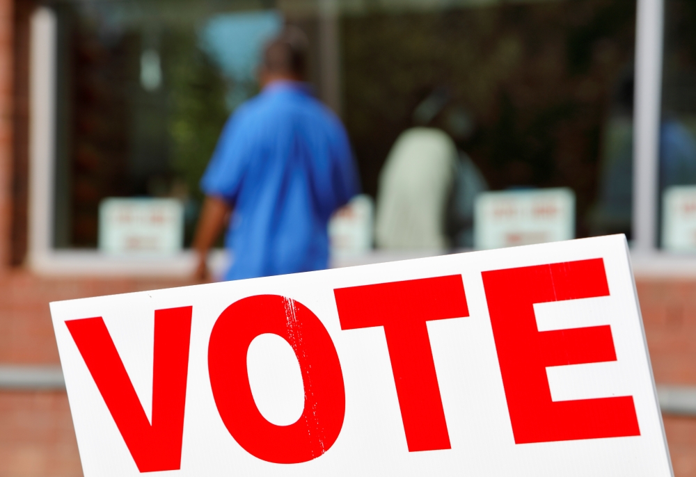 Signs direct voters into a polling station during the 2020 U.S. presidential election in Durham, Durham County, North Carolina, U.S., November 3, 2020. REUTERS/Jonathan Drake
