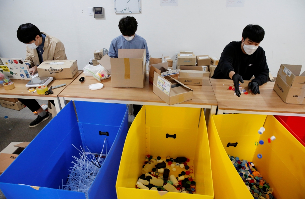 Volunteers separate different types of plastic at Plastic Mill in Seoul, South Korea, October 29, 2020. Picture taken October 29, 2020. REUTERS/Heo Ran