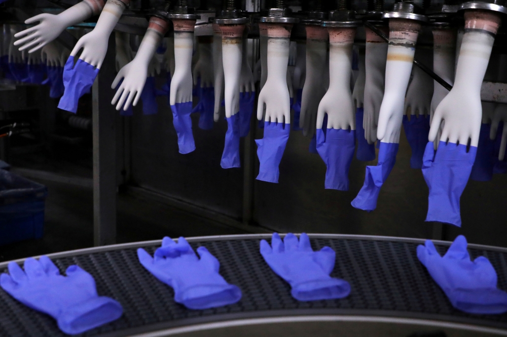 Newly-made gloves are pictured inside Top Glove factory in Shah Alam, Malaysia August 26, 2020. REUTERS/Lim Huey Teng/File Photo/File Photo