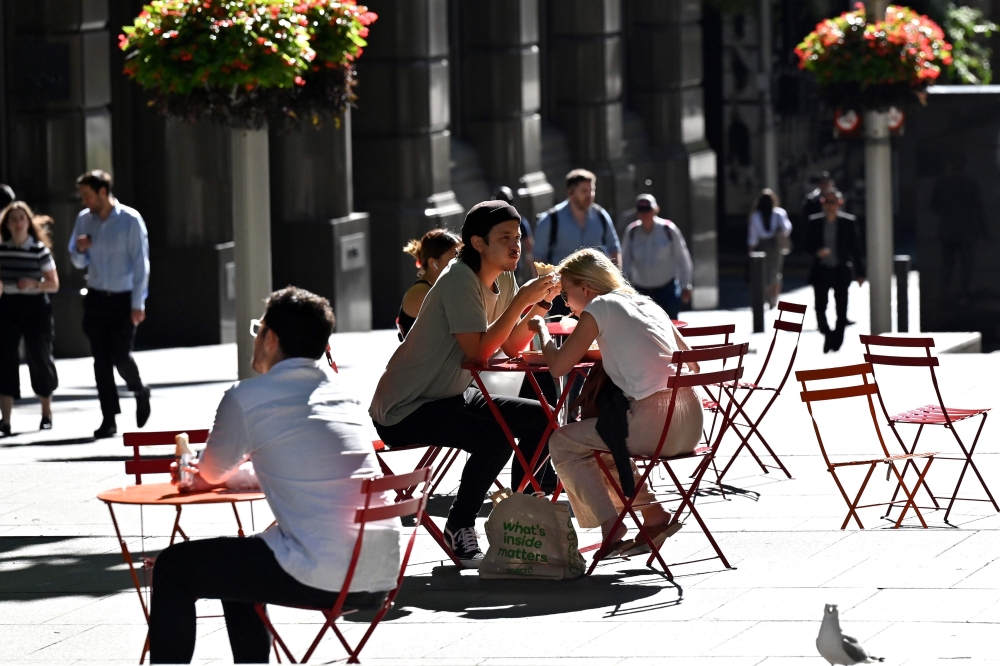 People spend their lunch hour in the central business district of Sydney on November 3, 2020. AFP / Saeed Khan 