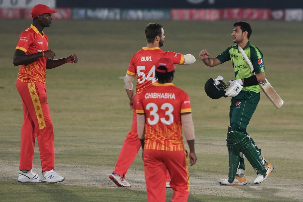 Pakistan's Haider Ali (R) interacts Zimbabwe's Ryan Burl after winning the second Twenty20 cricket match between Pakistan and Zimbabwe at the Rawalpindi Cricket Stadium in Rawalpindi on November 8, 2020. / AFP / Aamir QURESHI
