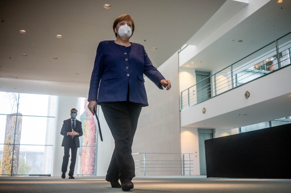 German Chancellor Angela Merkel wears a protective mask as she arrives to give a statement on the outcome of the 2020 U.S. presidential election in Berlin, Germany, November 9, 2020. Michael Kappeler/Pool via REUTERS