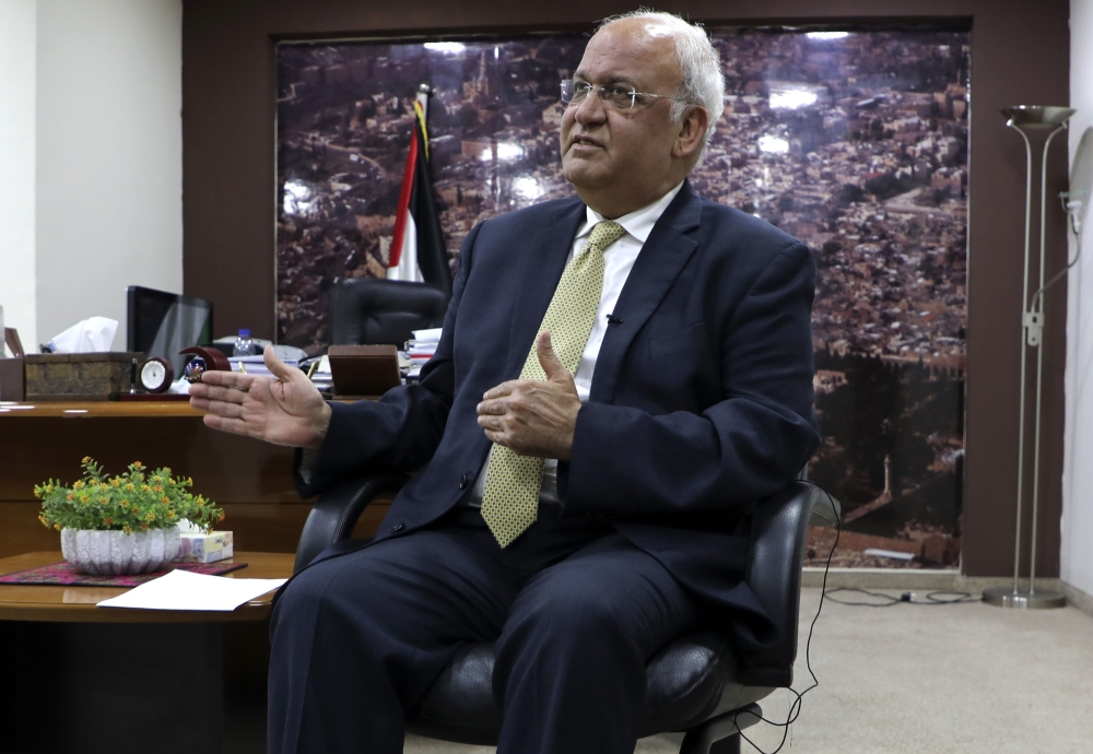 (FILES) A file photo taken on March 3, 2020 shows Saeb Erekat, Secretary-General of the Palestine Liberation Organisation and chief Palestinian negotiator, talking to reporters in the West Bank city of Ramallah. AFP / Abbas Momani 