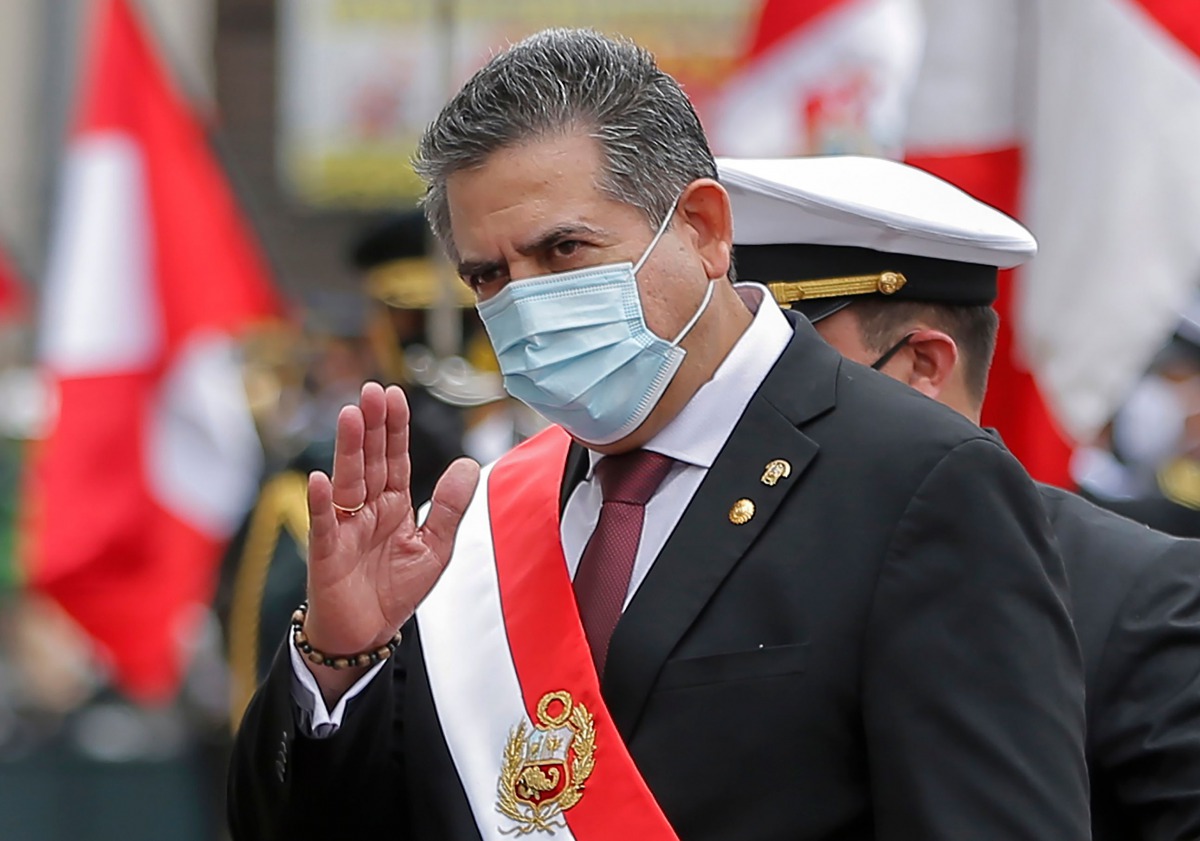 (FILES) In this file picture taken on November 10, 2020 the head of the Peruvian Congress, Manuel Merino, waves after being sworn in as interim President in Lima, day after the Congress voted to impeach and oust President Martin Vizcarra over corruption a