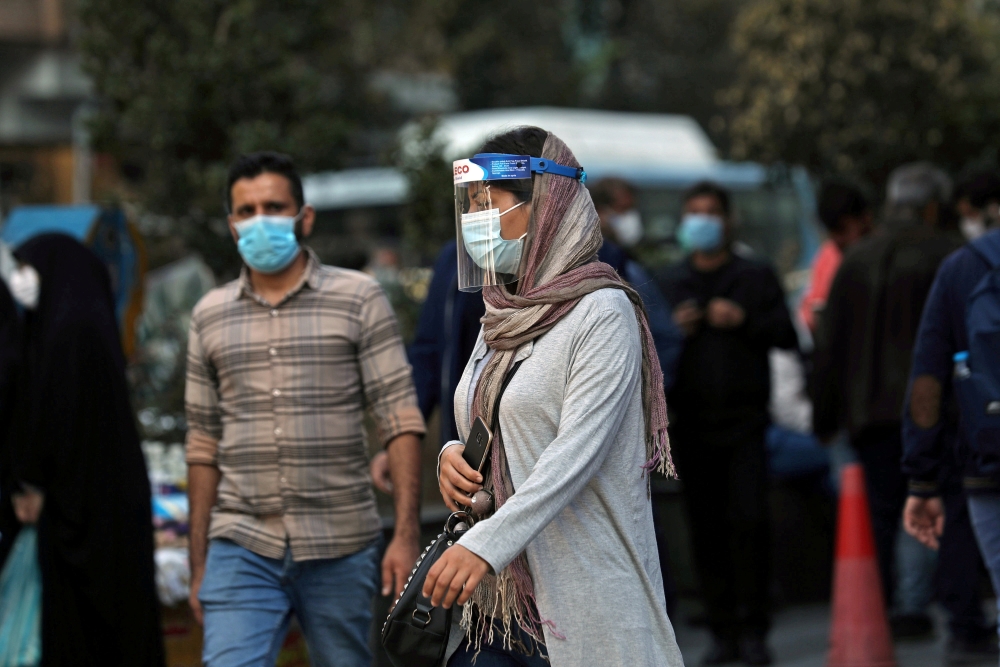 FILE PHOTO: An Iranian woman wears a mask and face shield, amid a rise in the coronavirus disease (COVID-19) infections, in Tehran, Iran October 24, 2020. Picture taken October 24, 2020. Majid Asgaripour/WANA (West Asia News Agency) via REUTERS 

