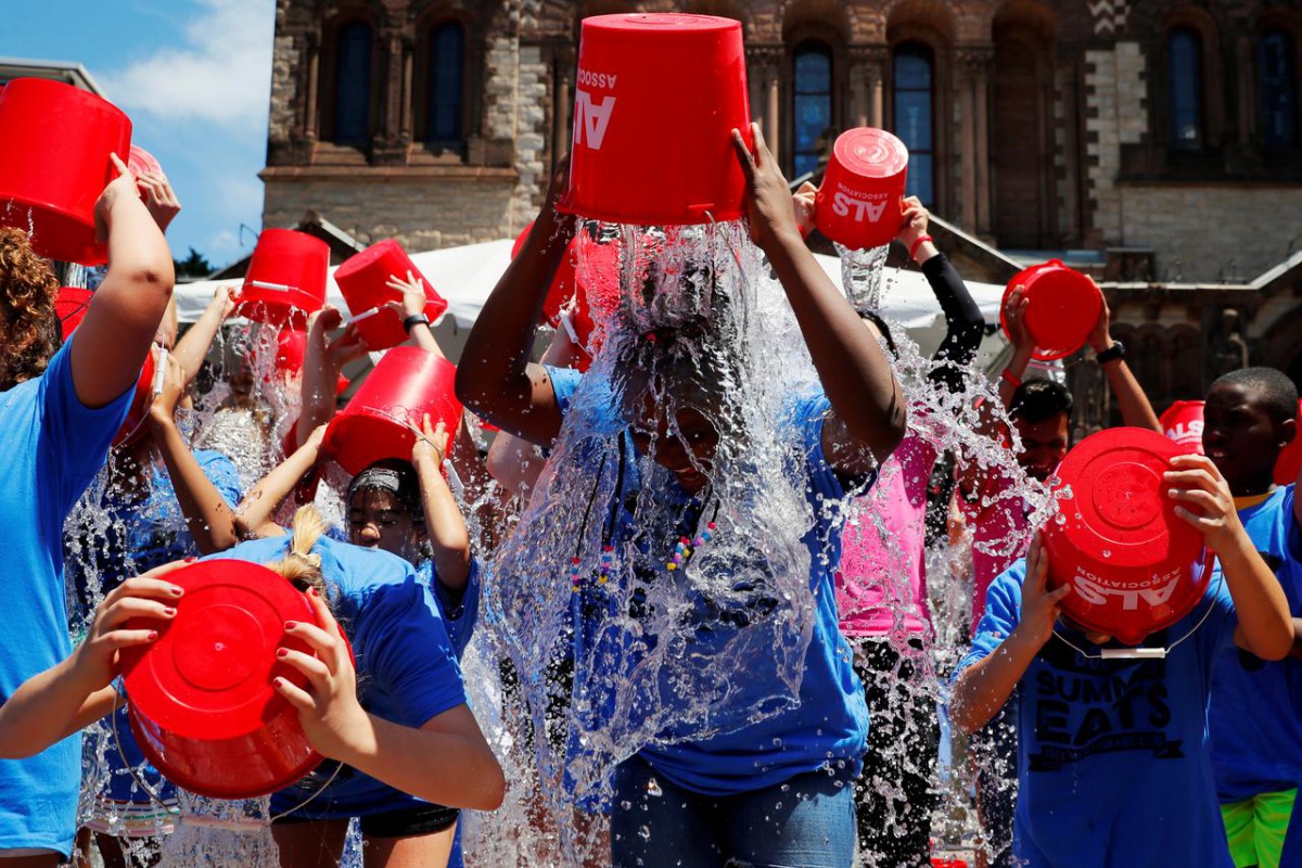 FILE PHOTO: Eleven-year-old Jahziyah Jones, with a crowd of others, pours a bucket of ice water over her head during an event to commemorate the five year anniversary of the 