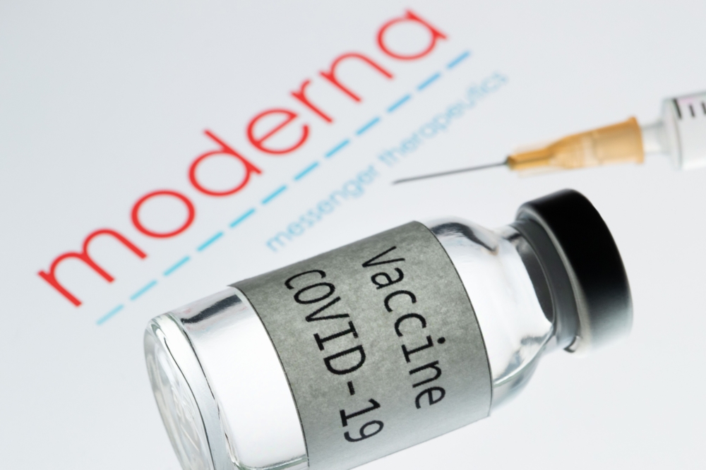 This picture taken on November 18, 2020 shows a syringe and a bottle reading 