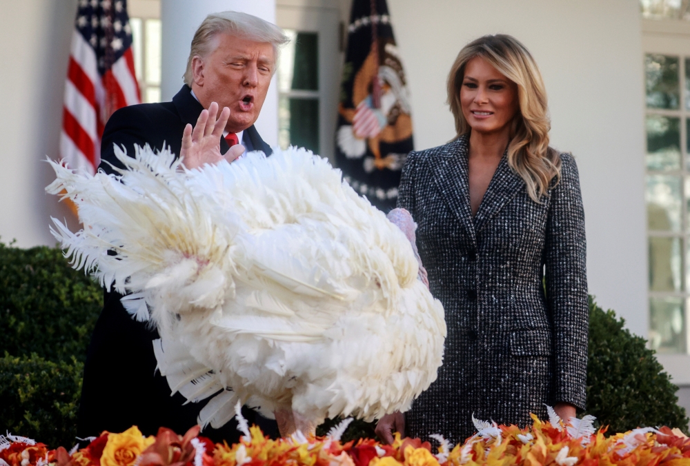 US President Donald Trump stands with first lady Melania Trump as he pardons the National Thanksgiving Turkey 