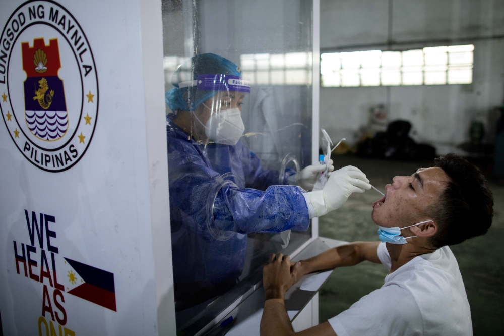 File photo: A vendor at Pritil Public Market gets a free swab test amid the coronavirus disease (COVID-19) outbreak, in Tondo, Manila, Philippines, October 8, 2020. Reuters/Eloisa Lopez/File Photo