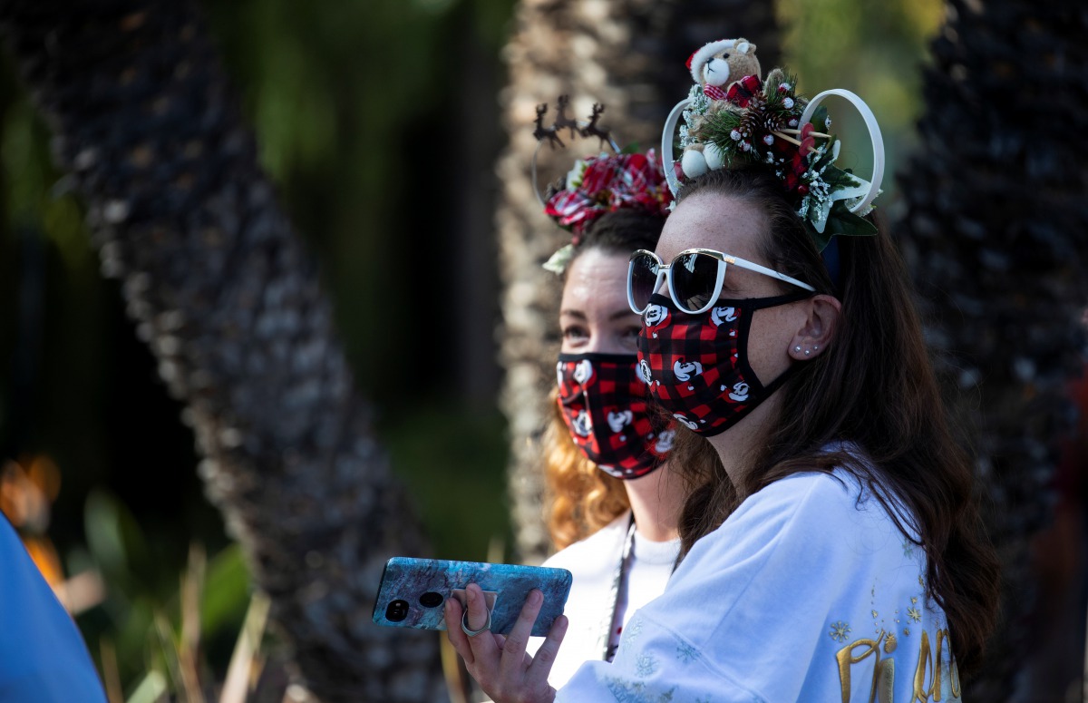 Cheryl Ooley and Stephanie Horning wait to get inside Disney California Adventure as its retail stores and restaurants partially reopened without rides during the outbreak of the coronavirus disease (COVID-19), in Anaheim, California, U.S., November 19, 2