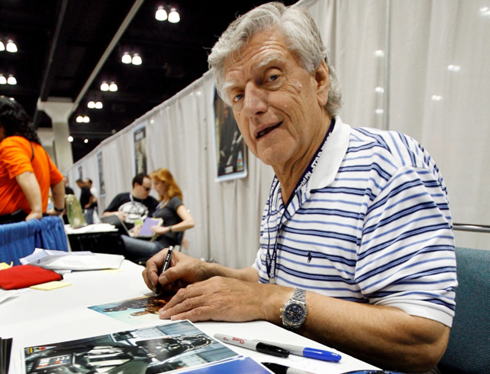 Actor David Prowse, who portrayed Darth Vader, signs autographs during the opening day of 
