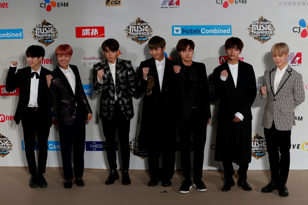 Members of South Korean K-pop band BTS, also known as Bangtan Boys, pose on the red carpet during Mnet Asian Music Awards (MAMA) in Hong Kong, China December 2, 2016. REUTERS/Bobby Yip/File Photo