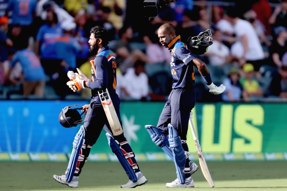 India's batsmen Hardik Pandya (R) and Ravindra Jadeja walk back to the pavilion at the end of 50 overs during the third one-day international cricket match between Australia and India at Manuka Oval in Canberra on December 2, 2020. AFP / David Gray  