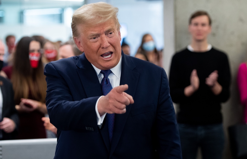 FILE PHOTO: US President Donald Trump points as he visits his campaign headquarters in Arlington, Virginia, November 3, 2020.  AFP / SAUL LOEB