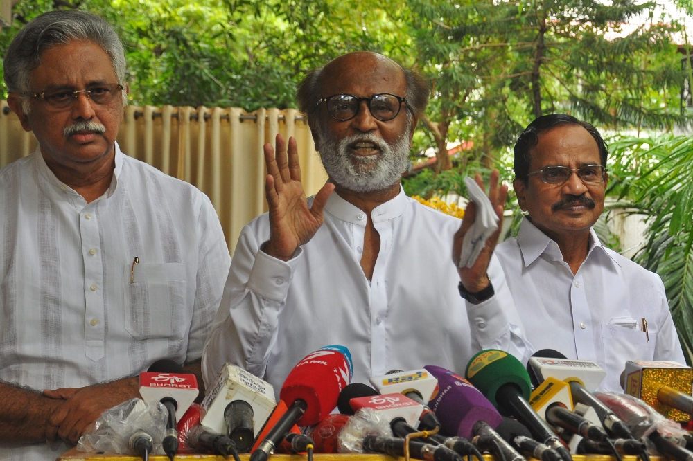 Indian actor Rajinikanth (C) addresses the media representatives in front of his residence in Chennai on December 3, 2020. AFP 