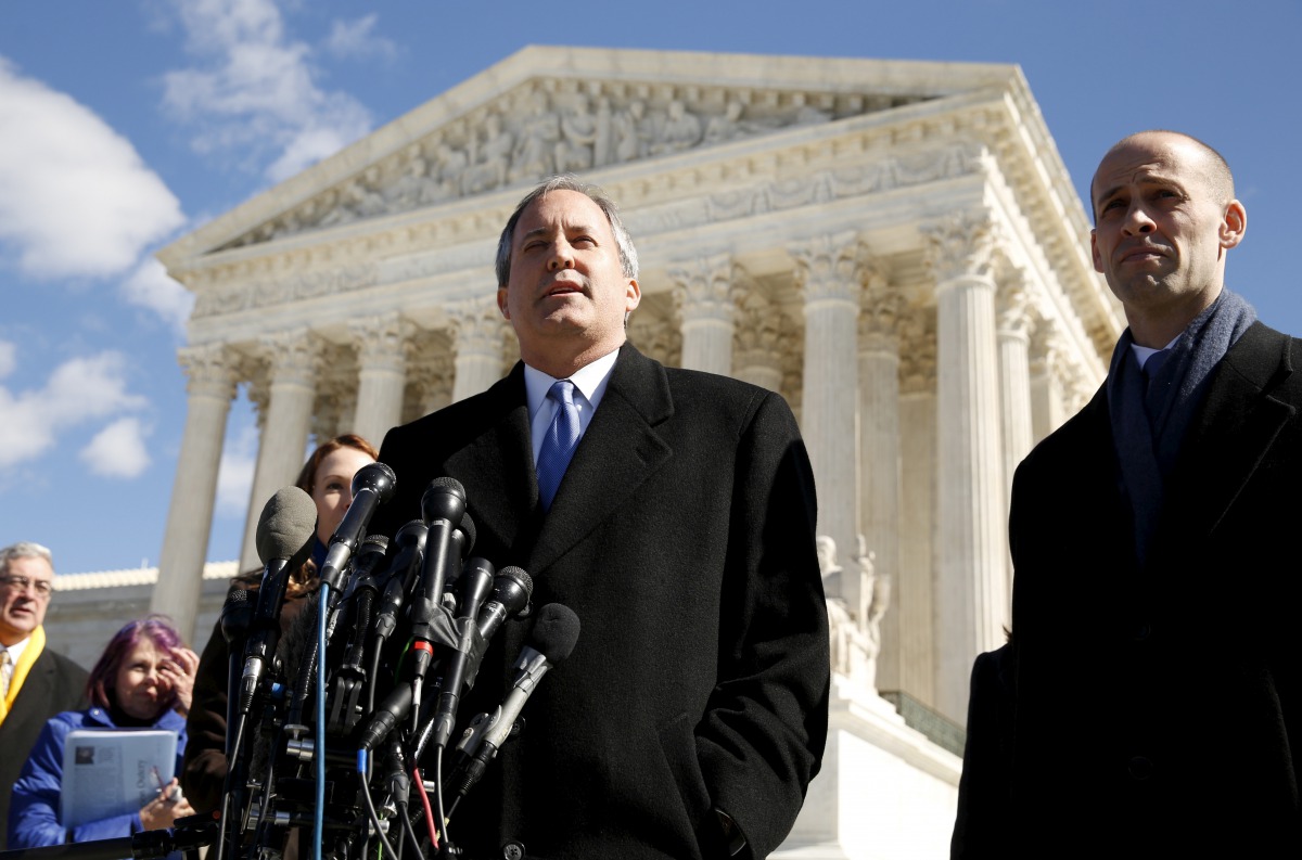 FILE PHOTO: Texas Attorney General Ken Paxton addresses reporters on the steps of the U.S. Supreme Court in Washington March 2, 2016.REUTERS/Kevin Lamarque/File Photo
