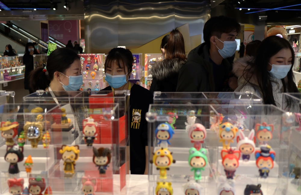 People wearing masks, following the coronavirus disease (COVDI-19) outbreak, are seen inside a store of Chinese toy maker Pop Mart at a shopping mall in Beijing, China December 9, 2020. Picture taken December 9, 2020. REUTERS/Tingshu Wang
