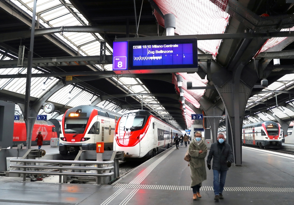FILE PHOTO: A display shows the departure time of a train of Swiss train operator SBB from Zurich to Milan, Italy, REUTERS/Arnd Wiegmann
