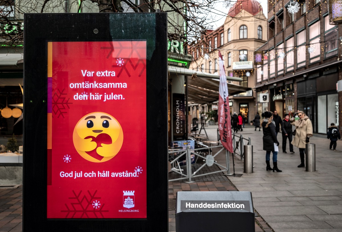 An information sign wishing Merry Christmas and asking to maintain social distancing is seen at a pedestrian shopping street amid the spread of the coronavirus disease (COVID-19) in Helsingborg, Sweden, December 7, 2020. Johan Nilsson/TT News Agency/via R