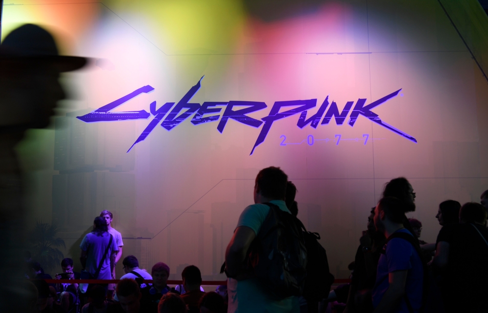 In this file photo taken on August 21, 2019 visitors wait at the Cyberpunk 2077 stand during the Video games trade fair Gamescom in Cologne, western Germany. Sony said on December 18, 2020 it was pulling the much-hyped Cyberpunk 2077 from PlayStation stor